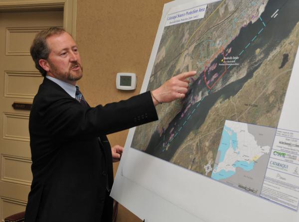 Planner Jonathan Faurschou points to the location of a planned underwater condominium complex in Brockville waters.